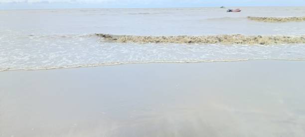 istock Close up of small waves breaking near the shore 2196502629