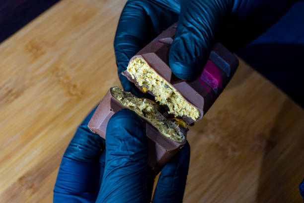 istock black-gloved hand holds Dubai chocolate 2196503148