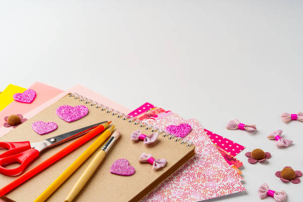 Crafting colorful decorations with paper, scissors, and embellishments on a tabletop
