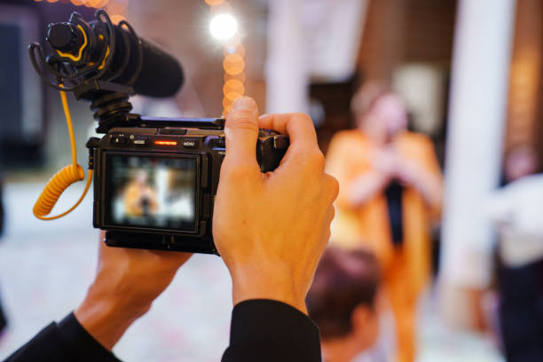 istock Men's hands with a professional camera are filming a performance at a banquet. 2196503942
