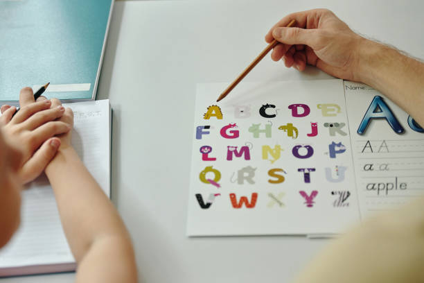 istock Schoolgirl Learning ABC With Teacher 2196504469