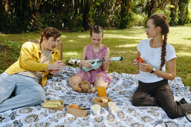 istock Girl Having Picnic With Her Parents 2196504599