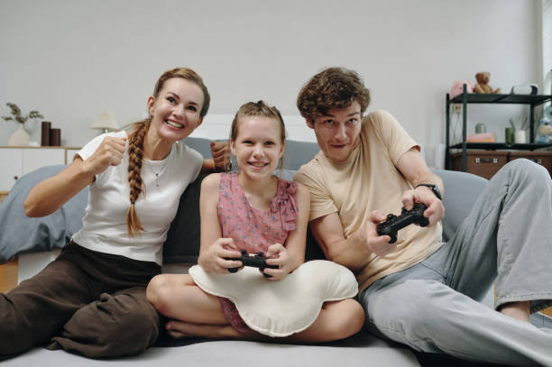 istock Family Playing Video Game In Team 2196505301