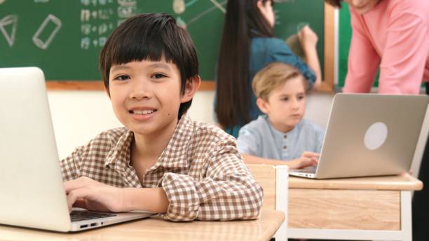 istock Boy coding engineering prompt while attractive girl drawing picture. Pedagogy. 2196505426