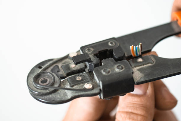 istock Electrician stripping wires with a tool, close-up. 2196505910