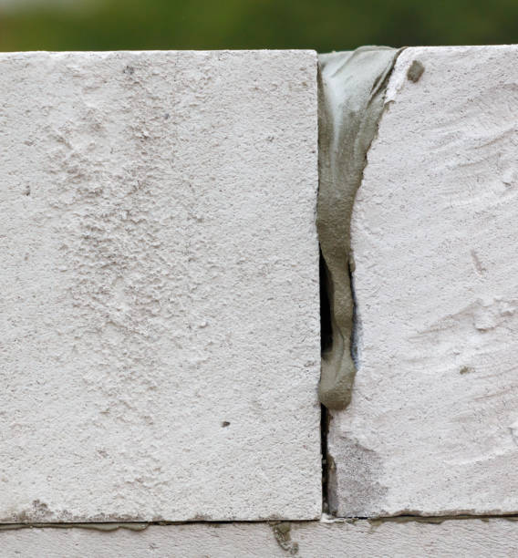 istock A wall with a crack in it and a white substance oozing out of it 2196506078