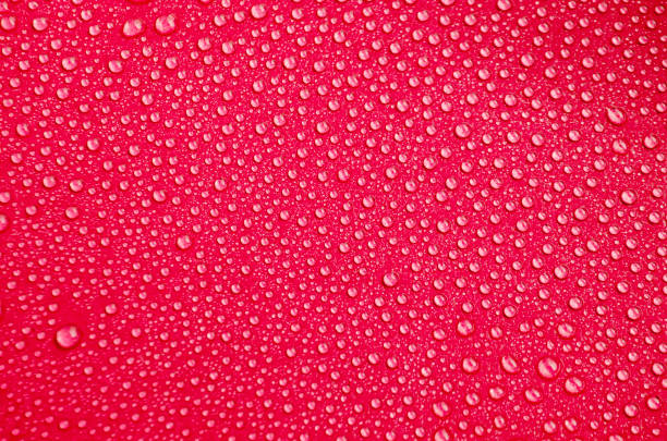 istock Detailed View of Droplets Resting on Red Background 2196510240