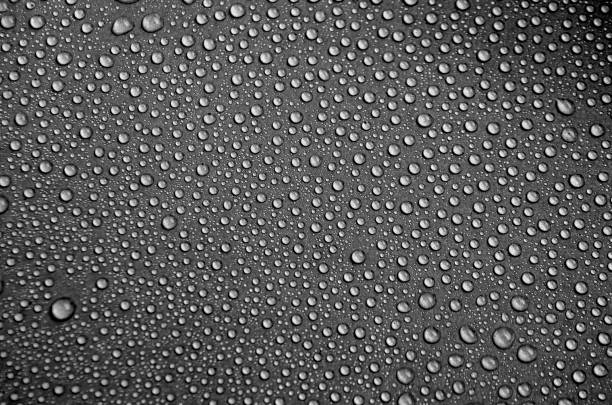 Water droplets with dark background suitable for wallpaper Water droplets with dark background suitable for wallpaper. water on black surface stock pictures, royalty-free photos & images