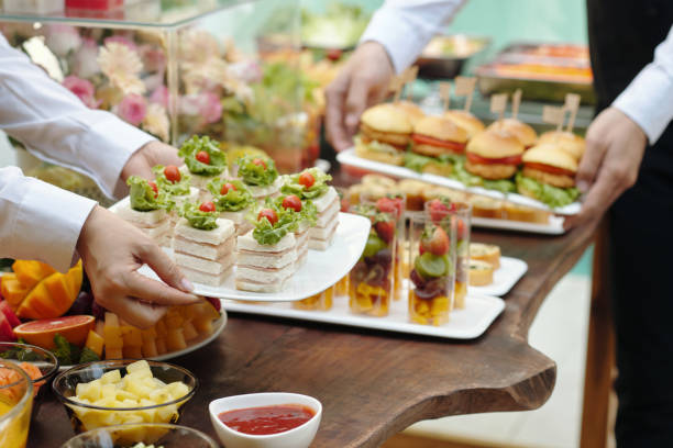 Waiters arranging buffet with various appetizers