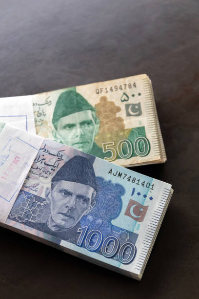 Pakistani currency note closely on wooden background. stock photo