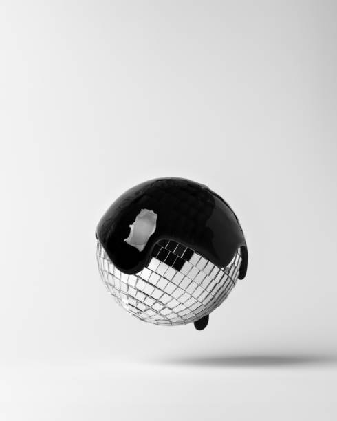 istock Sleek disco ball coated with glossy black drip, floating against a white backdrop, merging nightlife glam with modern art minimalism. 2196513143