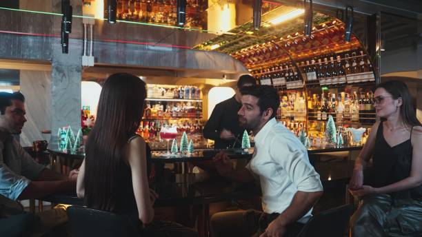 istock Guest siting at counter bar discussing with friend waiting for drinks. Vinosity. 2196513550