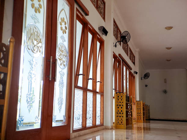 istock Interior view of a mosque with stained glass windows featuring intricate Islamic calligraphy 2196515703