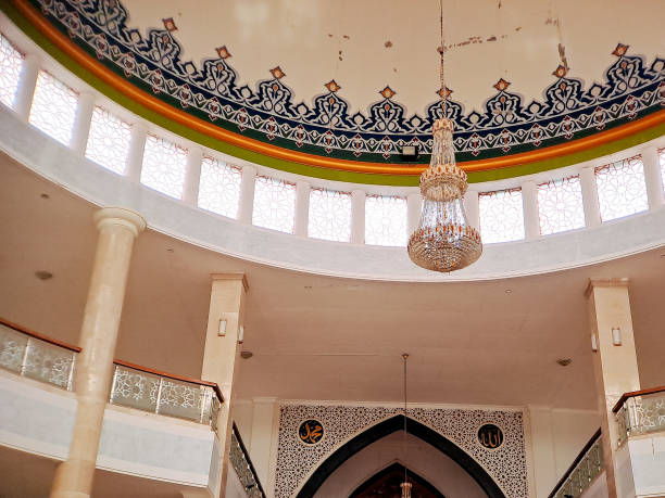istock crystal chandelier illuminates the interior of a mosque with a painted dome ceiling featuring intricate Islamic motifs 2196515745