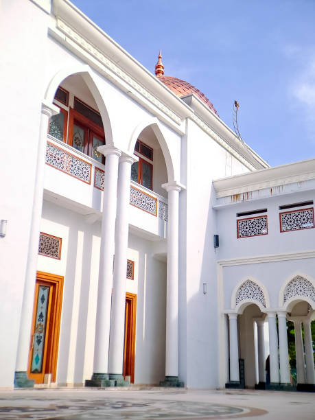 istock majestic white mosque with a red tiled dome, showcasing its intricate architectural details against a clear blue sky 2196515952