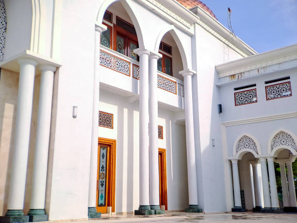 istock majestic white mosque with a red tiled dome, showcasing its intricate architectural details against a clear blue sky 2196515954