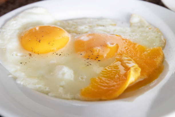 istock Delicious fried eggs with vibrant orange yolks. 2196516184