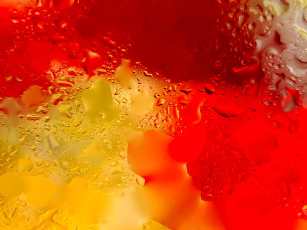 istock Abstract background with water droplets on a surface, creating a vibrant interplay of yellow and red colors 2196516465