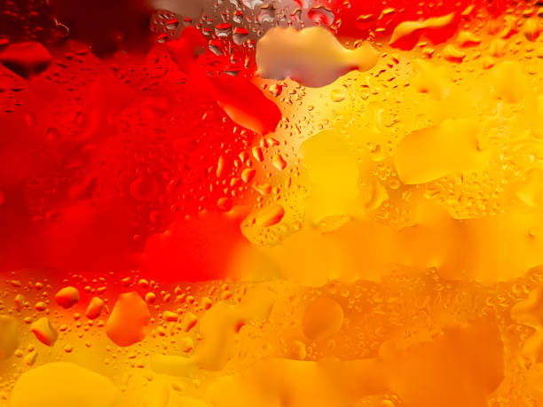 istock Abstract background with water droplets on a surface, creating a vibrant interplay of yellow and red colors 2196516471