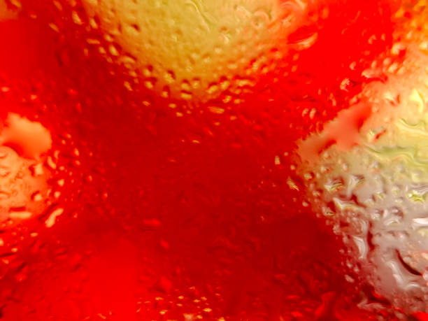 istock Abstract background with water droplets on a surface, creating a vibrant interplay of yellow and red colors 2196516474