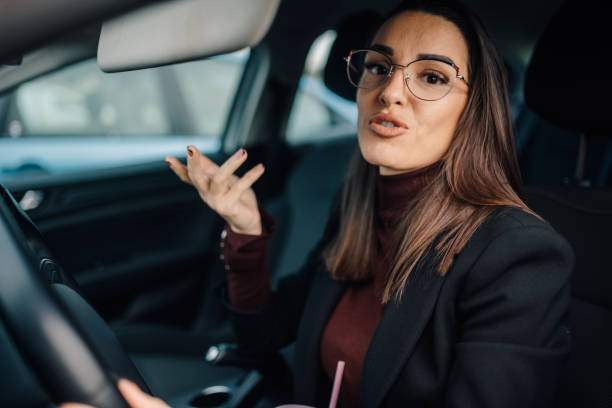 istock Businesswoman gesturing while driving and talking in her car 2196524464
