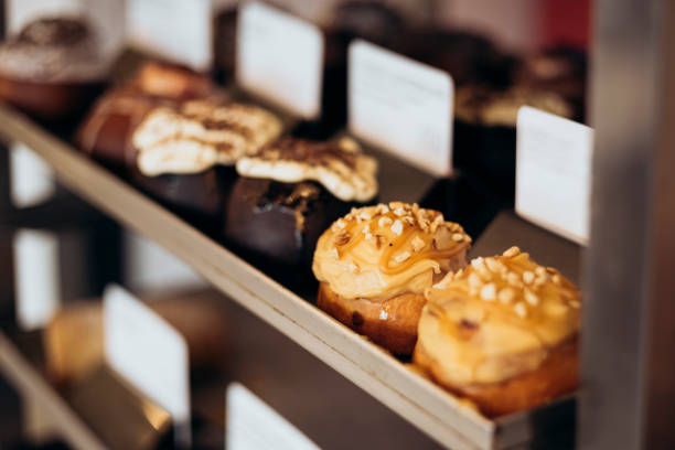 istock Appetizing cinnamon buns with cream in the bakery window. 2196526954