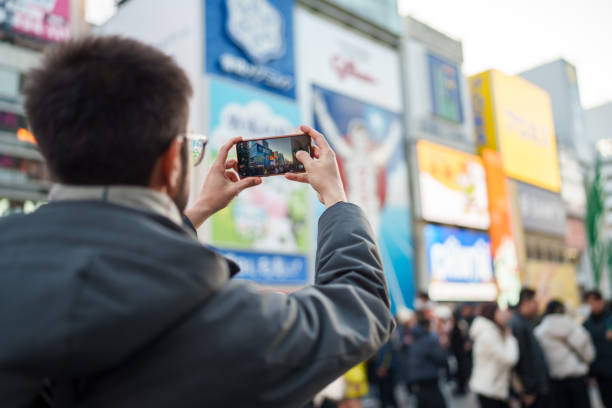 istock Man photographing with mobile phone in Dotonbori Osaka. 2196527600