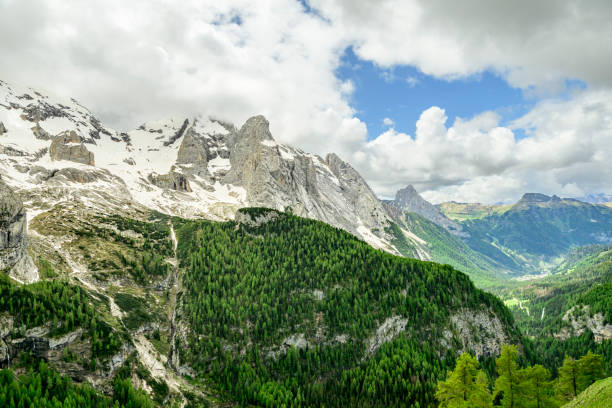 View along the Viel dal Pan hiking path over the Padon chain in the Dolomites during springtime. View over the Val di Fassa and Marmolada mountain range.
