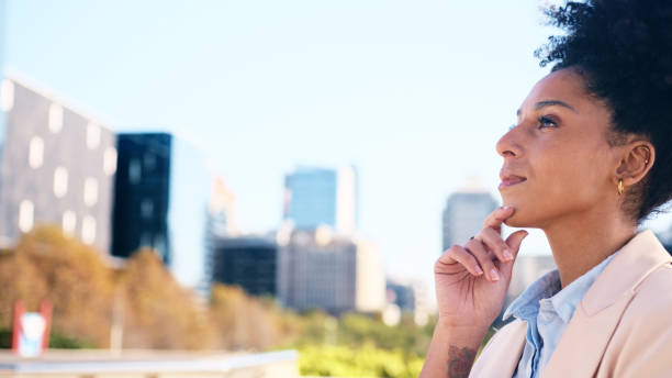 istock Thoughtful Young Woman in Professional Attire Standing Outdoors in Urban Setting 2196531201