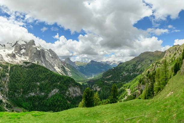 View along the Viel dal Pan hiking path over the Padon chain in the Dolomites during springtime. View over the Val di Fassa and Marmolada mountain range.