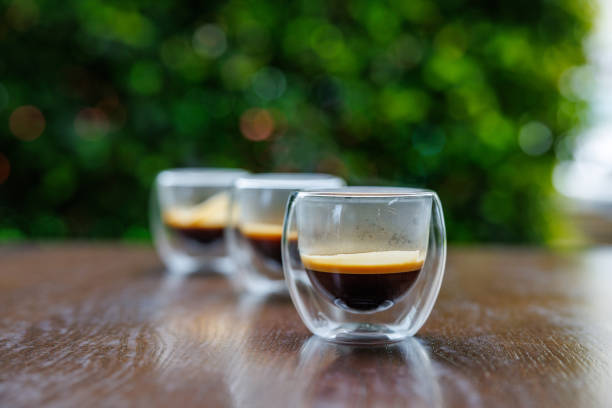 Three transparent glass espresso cups on the table outdoors