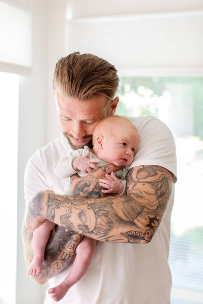 istock Dad holding his newborn baby 2196532742