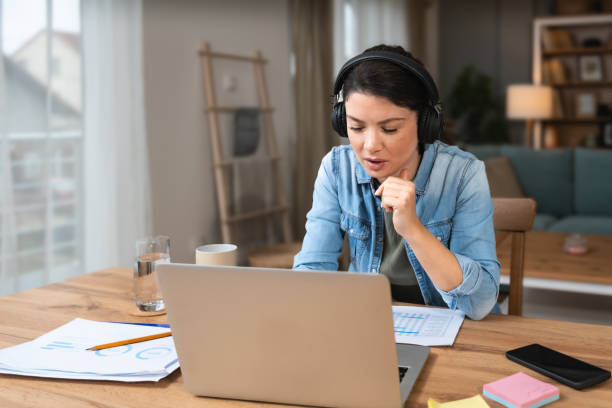 istock Young freelance businesswoman attending online educational class on laptop computer webcam teleconference in progress watching and listening educator expert about economy and finance. Online business 2196532863