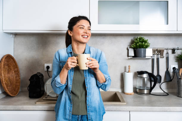 istock Young happy freshly divorced or recently single woman after toxic relationship breakup standing at kitchen in new apartment she rent drinking coffee or tea enjoying new beginnings and morning silence 2196532905