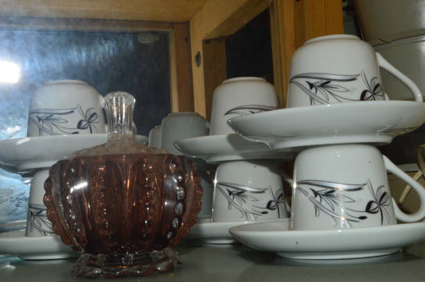 istock Glass cups, plates in a showcase as a decorative feature in a living room, 2196532926