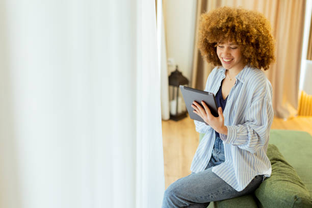 istock Engaging with digital content while relaxing in a cozy, well-lit room during a leisurely afternoon 2196533685