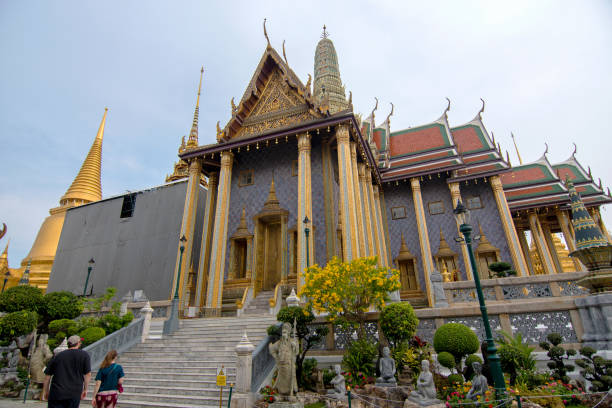 Visitors walk around Wat Phra Kaew, considered the sacred Buddhist temple in Thailand and one of Bangkok's most popular tourist attractions.