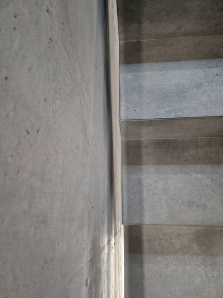 istock cast staircase made of monoblock reinforced concrete. there is a significant gap between the stairs and the wall. this detail of the joint or expansion lightens the visual mass 2196538603