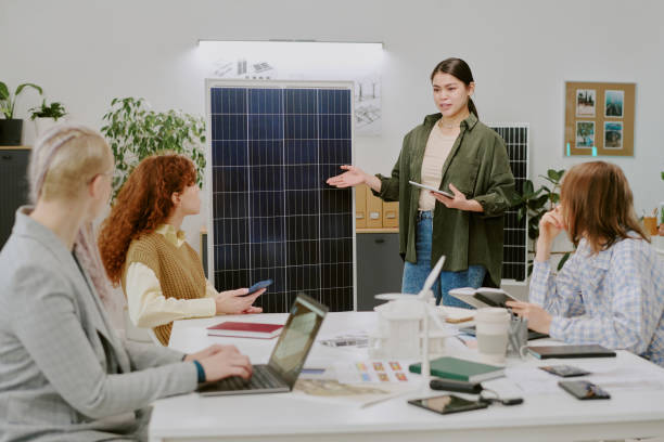 istock Discussing Renewable Energy with Diverse Team in Office Setting 2196538658