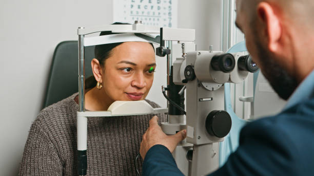 istock Optometrist Conducting Eye Exam for Patient Using Medical Equipment 2196539022