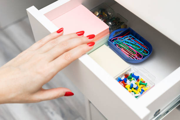 istock female hand opens desk drawer with office supplies 2196539781