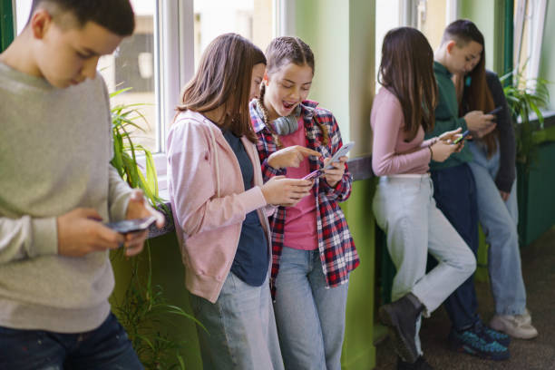 istock Children look at cell phones during break at school 2196540276
