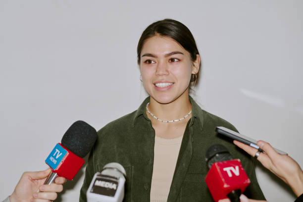 istock Smiling Woman Being Interviewed by Journalists 2196540550