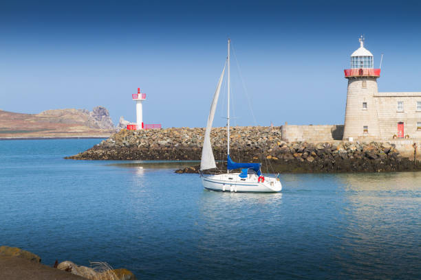 Lighthouse in Howth, an Irish town on the Howth Peninsula Dublin Ireland. View of calm blue sea and clear sky
