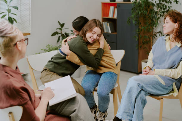 istock Group of Friends Hugging and Laughing Together 2196542592
