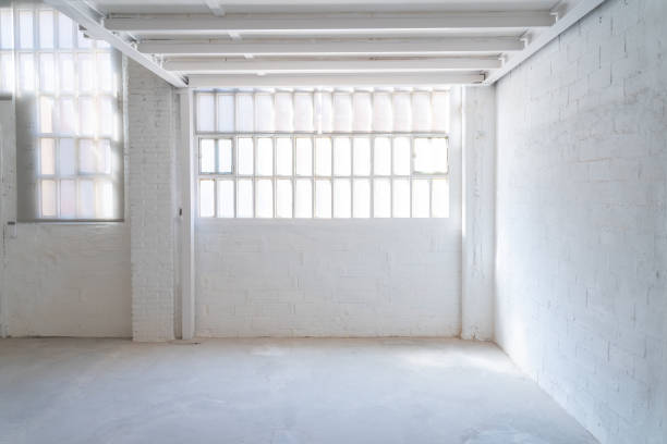 istock Empty industrial space with white walls and a door background with copy space for text. 2196542885