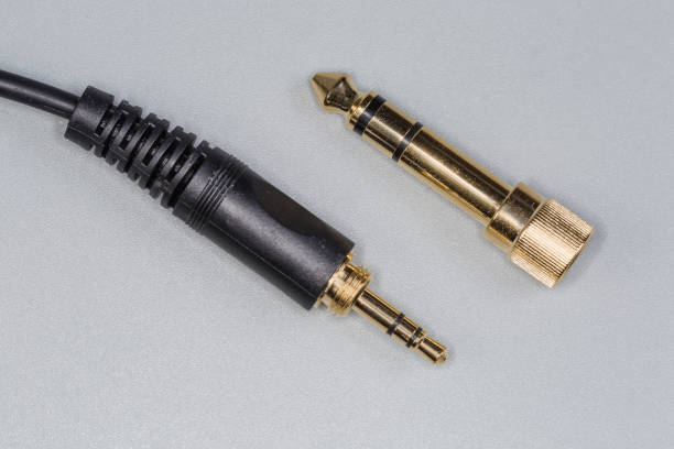 The humble jack audio connector is elevated to a work of art. The metallic contours shimmer under the light, while the precision-engineered grooves and ridges speak to its functionality.