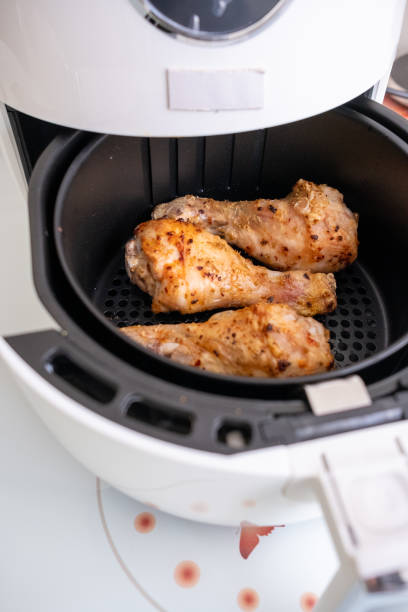 istock Frying chicken legs in white airfryer in close-up 2196545053