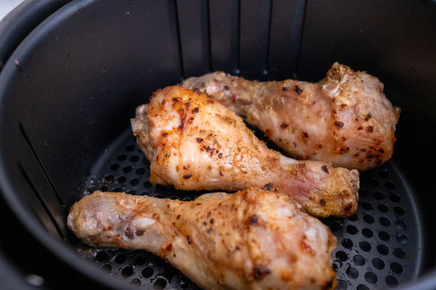 istock Frying chicken legs in white airfryer in close-up 2196545115