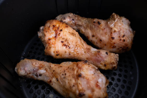 istock Frying chicken legs in white airfryer in close-up 2196545132